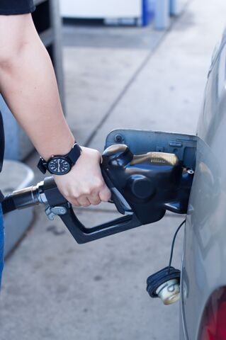 close-up-woman-hand-putting-gas-into-car-gas-station
